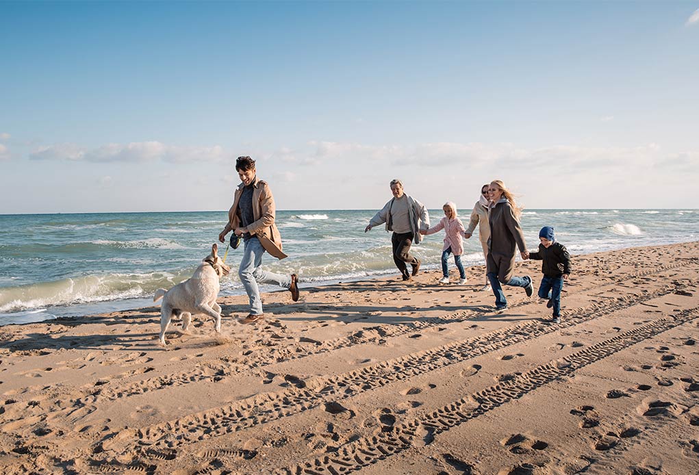grandparents and family running on beach what are taxes on retirement income