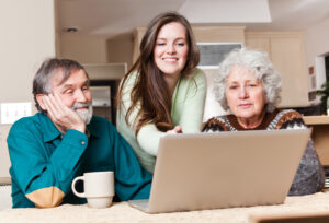 granddaughter on laptop with grandparents webinars